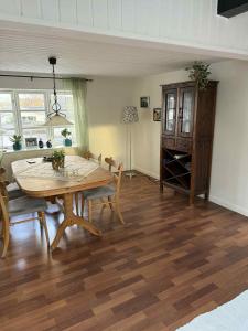 a living room with a wooden table and chairs at Tylstrup Nordjylland in Tylstrup
