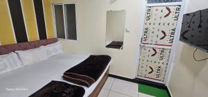 ein kleines Zimmer mit einem Bett und einem Spiegel in der Unterkunft Hotel matra kripa in Ujjain + 25 Fotos