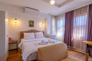 a hotel room with a bed with two towels on it at Oldcity homes hotel in Istanbul +10 photos