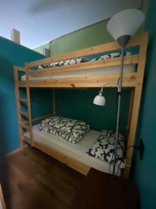 two bunk beds in a room with a lamp at Il Sole di Ester in Branzi
