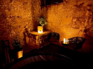 a room with two chairs and a table with candles at Les clés du désir in Épône