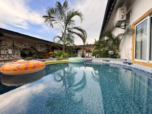 a swimming pool with inflatable balls in a house at Retreat Cameroon BASTOS in Yaoundé