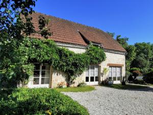 a brick house with windows and a brown roof at Laborie in Meyronne