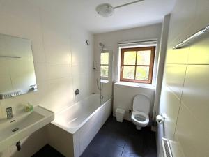 a white bathroom with a sink and a toilet at Select Apartment TOP 8 Kaprun Fürth by Jara in Piesendorf