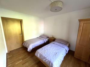 a room with two beds in a room with a door at Select Apartment TOP 8 Kaprun Fürth by Jara in Piesendorf