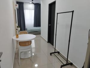 a room with a white table and a mirror at Studio Unit Marc Residence in Bukit Mertajam