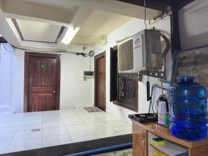a kitchen with a sink and a counter top at The Luang Prabang Hostel in Luang Prabang