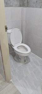 a bathroom with a white toilet in a stall at Yao Noi Hostel by KR in Ko Yao Noi