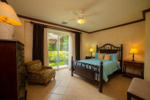 a bedroom with a bed and a chair and a window at Bay Residence 9F 3 bdr Garden View in Los Suenos in Jacó +35 photos