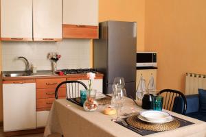 a kitchen with a table with a table cloth on it at La Corte Segreta - Dimora nel cuore di Urbino in Urbino