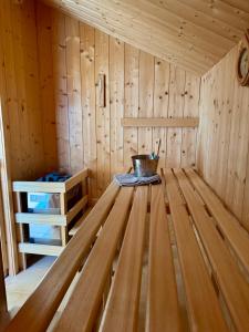 a inside of a sauna with a bucket in it at Gipfelruhe-ganzes Ferienhaus mit Sauna, Garten & Spielzimmer- Ramsau am Dachstein in Ramsau am Dachstein