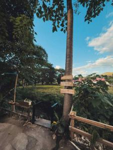a pole and a fence next to a tree at Tropical Project in Pai in Pai +22 photos