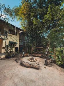 a house with a log in front of a yard at Tropical Project in Pai in Pai