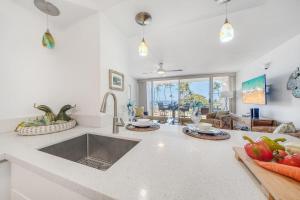 a kitchen with a sink and a counter top at Island Surf 306 · ISF 306 1BD w Ocean Views AC Pool Near Beach in Kihei