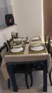 a dining room table with a white table cloth and chairs at Alzira casa completa Iguaba in Iguaba Grande +37 photos