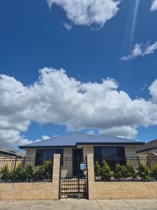 a house with a fence in front of it at Dalyellup 2BR accommodation-Rear Guest house Unit- Walkable to major supermarkets in North Boyanup