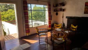 a room with chairs and a table and a window at Mountain house in Costa Blanca in Cuesta Blanca