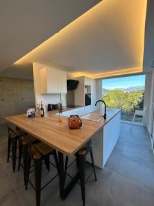 a kitchen with a large wooden table and a sink at 5 bedroom house, office, laundry room in Colomars