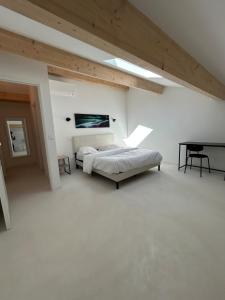 a white room with a bed and a desk in it at 5 bedroom house, office, laundry room in Colomars
