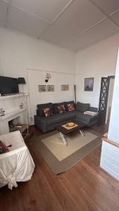 a living room with a couch and a fireplace at Casa Morgado do Casco in Estremoz