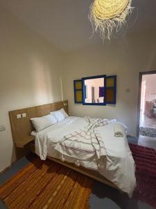 ein Schlafzimmer mit einem Bett und einem Spiegel an der Wand in der Unterkunft Sunrise Camp in Mirleft