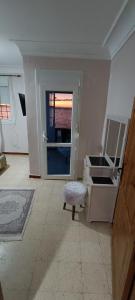 Maison Au bord de la mere في Mostaganem: غرفة فيها باب وكرسي ونافذة +14 صورة
