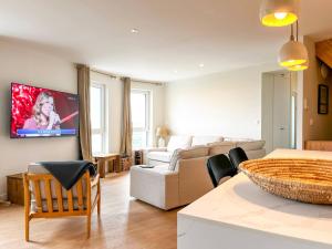 a living room with a couch and a table at John in Étaples