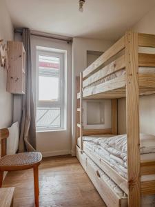 a bedroom with two bunk beds and a window at John in Étaples