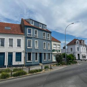 a blue building on the side of a street at John in Étaples