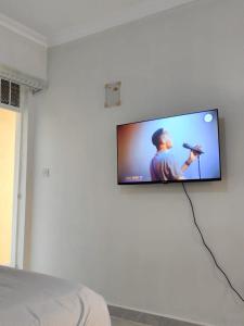 a flat screen tv hanging on a wall at Luxe Homes in Meru