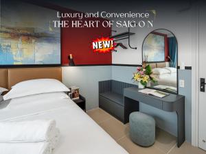 a hotel room with a bed and a desk with a sign at The Heart of Saigon - International Plaza - Ho Chi Minh City Hall in Ho Chi Minh City