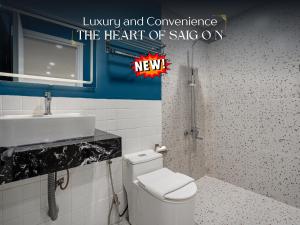 a bathroom with a white toilet and a sink at The Heart of Saigon - International Plaza - Ho Chi Minh City Hall in Ho Chi Minh City +52 photos