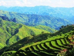a view of a valley with green hills and mountains at Placement For Cloud Hunting in Suy Tung Su +33 photos