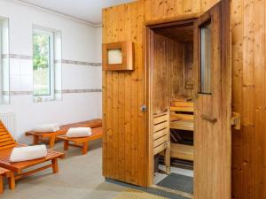 a room with a wooden door and a room with benches at Chalmová CHATA 27 in Bystričany +14 photos