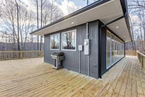 a house with a deck with a trash can at Primrose - Cave Run Lake OR Red River Gorge KY in Wellington