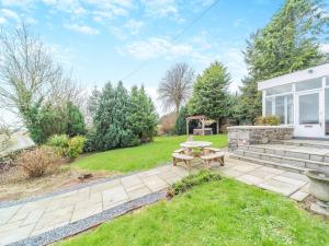a backyard with a picnic table and a gazebo at Airyhemming Farm in Glenluce