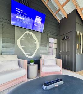 a room with two beds and a tv on the wall at Farmhouse at Montaluce Winery-2 Restaurants- Fast WIFI-Free Park-Hike-Weddings in Dahlonega