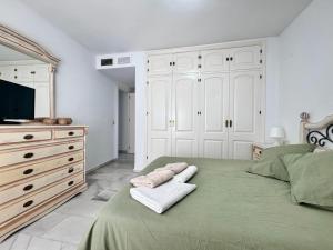a bedroom with a bed and a dresser and a television at Carihuela Playa Los Nidos 1 in Torremolinos +85 photos