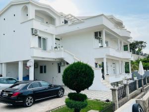 a black car parked in front of a white house at PrivatHomeUlcinj1 in Ulcinj +11 photos