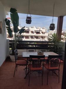 a dining room with a table and chairs and a building at El dulce in Pulpí +10 photos