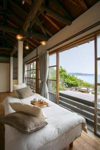 two beds in a room with a view of the ocean at mokumoku海sakanoshita in Kamakura