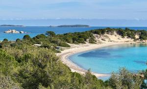 an island in the ocean with a sandy beach at Casetta di Asciaghju in Porto-Vecchio