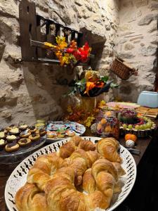 a table topped with plates of bread and pastries at Il Vicoletto in Artena