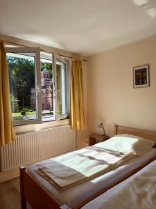 a bedroom with a bed and a large window at Hotel Appart in Osnabrück
