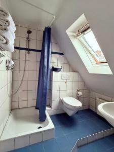 a bathroom with a shower with a toilet and a sink at Hotel Appart in Osnabrück +32 photos