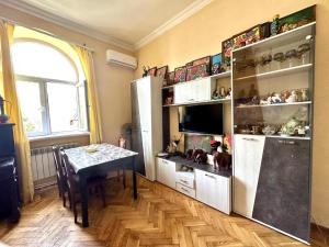 a kitchen with a table and a refrigerator at KAR & SON guesthouse in Yerevan +7 photos