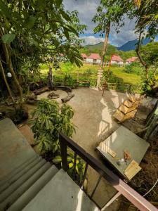 a view of a park with a bench and a garden at Tropical Project in Pai in Pai