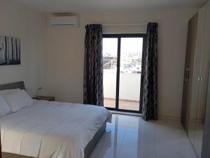 Ένα ή περισσότερα κρεβάτια σε δωμάτιο στο Cozy penthouse