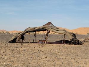 a tent in the middle of the desert at enjoy best night in desert merzouga in Merzouga