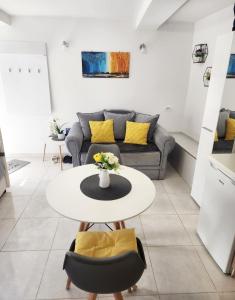 a living room with a table and a couch at Apartment Marina in Kotor